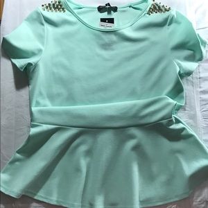 Mint green top with gold studs on the shoulders